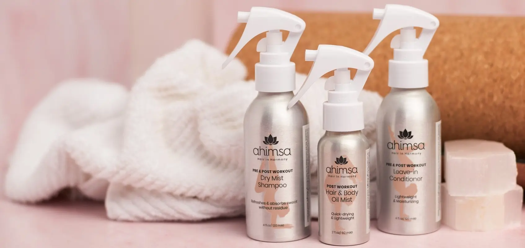  Ahimsa pre-workout hair care products flat lay — leave-in conditioner, dry mist shampoo, and oil mist for active women