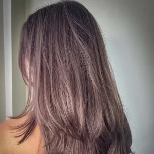 Close-up of woman with healthy shiny hair — why pre-workout hair prep protects against sweat damage