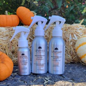 Ahimsa Dry Mist Shampoo, Leave-in Conditioner, and Hair Body Oil Mist with fall pumpkins — fall hair care routine for seasonal shedding